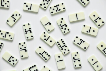 dominoes on a white background close up, domino effect