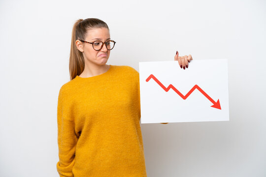 Young caucasian woman isolated on white background holding a sign with a decreasing statistics arrow symbol with sad expression