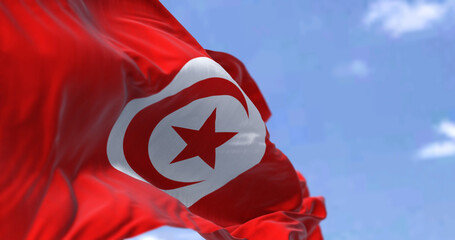 Detail of the national flag of Tunisia waving in the wind on a clear day