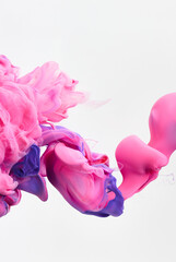 Beautiful pink paint splash curves in water on white. Acrylic paint drop background. Abstract colors swirl texture