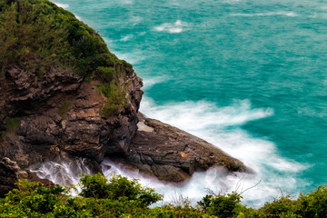 blue sea crashing cliffs