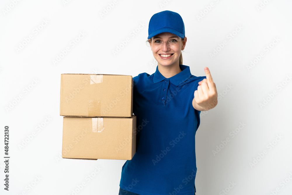 Wall mural Young delivery woman isolated on white background doing coming gesture