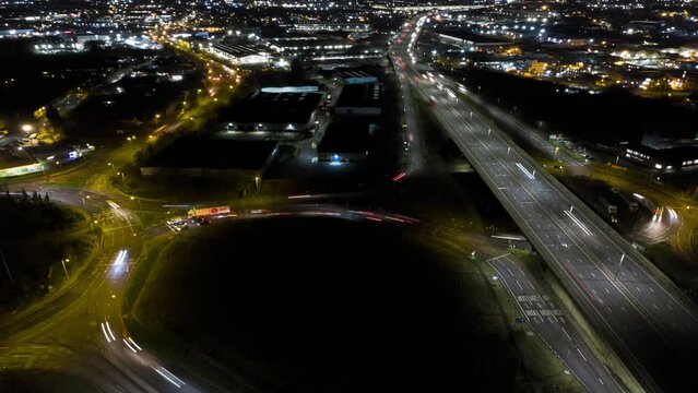 UK Motorway night timelapse aerial with rush hour traffic and light trails in London