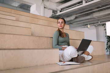 European girl using laptop computer and study