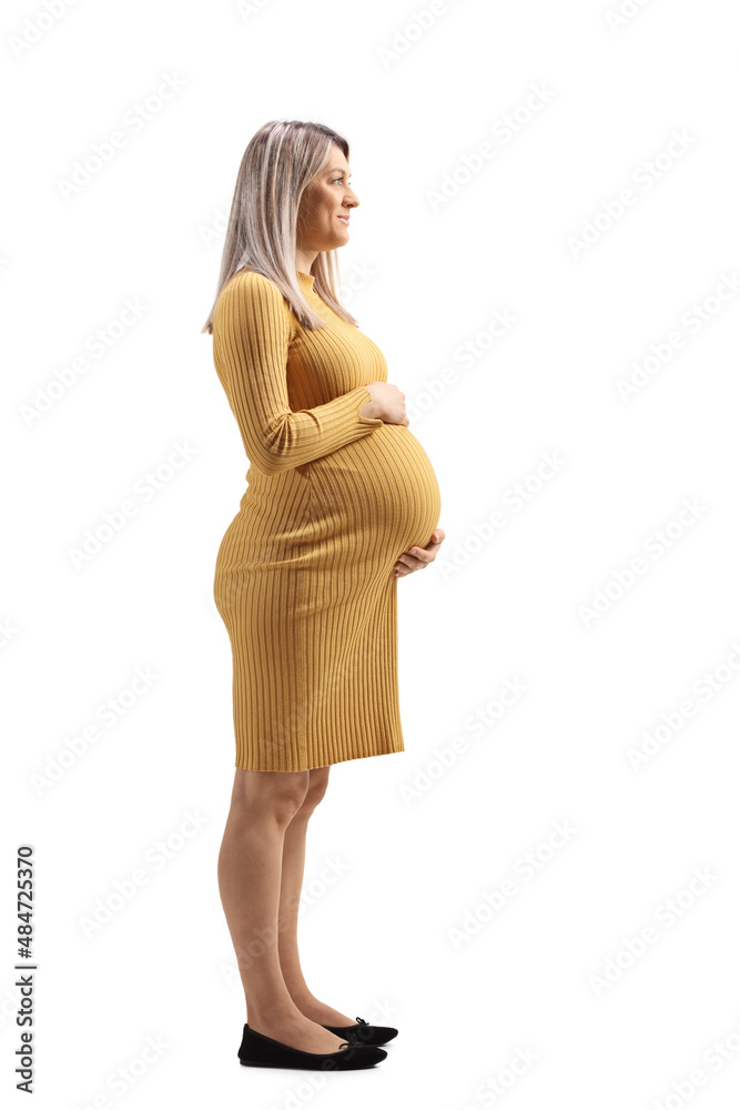 Canvas Prints full length profile shot of a pregnant woman in a yellow dress holding her tummy