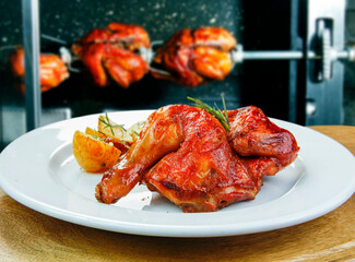 Roasted chickens in a row in a shop roaster