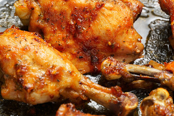 roasted chicken legs with aromatic crust, baked meat on a oven tray, tasty food close view