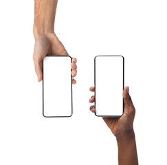 Couple showing two smartphones with empty screens closeup