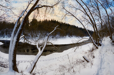 Evening winter landscape on the banks of the river