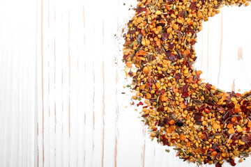 Mix of various spices close-up on a white wooden background with copy space. Textures of colorful spices and seasonings.