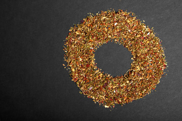 A mixture of various spices close-up on a black background with copy space. Textures of colorful spices and seasonings.