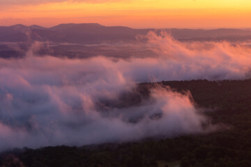 Fototapeta premium Colorful morning sunrise with golden glowing fog clouds over mountains at Arkansas Grand Canyon Scenic Point Overlook 