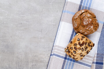 Gold rustic crusty loaves of bread and buns on wooden background. Still life captured from above top view, flat lay.