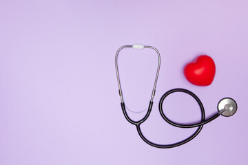 Stethoscope, red heart and space for text on purple background, flat lay. Health insurance concept.