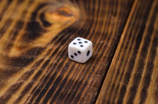 White dice for dice on a wooden table.
