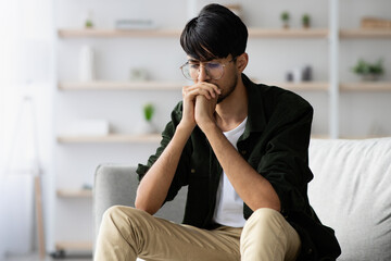 Stressed middle eastern young man suffering from crisis while pandemic