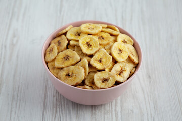 Homemade Banana Chips in a Pink Bowl, side view.