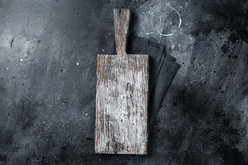 Cooking background with old empty cutting board. Black background. Top view. Copy space