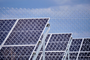 Ground based steel frame of large sustainable electrical power plant with rows of solar...
