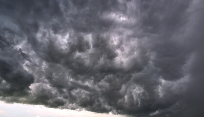 Landscape of dark ominous clouds like volcano eruption on stormy sky during heavy thunderstorm