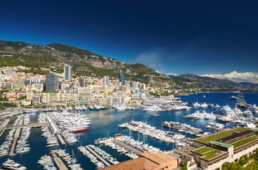 Fototapeta premium Aerial view of port Hercules in Monaco - Monte-Carlo at sunny day, a lot of yachts and boats are moored in marina, mediterranean sea