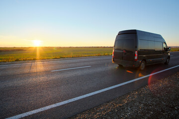 Small cargo van driving on highway hauling goods. Delivery transportation and logistics concept