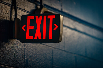 glowing exit sign by night on wall