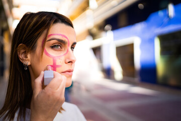 Woman with feminist icon sign drawn on her face