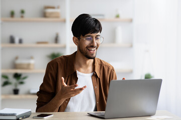 Charismatic middle eastern man having video call with colleagues