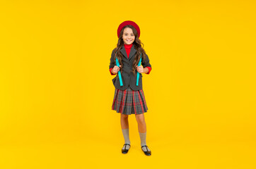 concept of education. kid in uniform on yellow background. september 1.