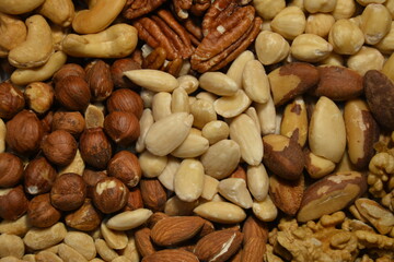 Different types of nuts: pecans, almonds, cashews, hazelnuts, peanuts, brazil nuts, walnuts. View from above
