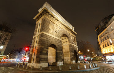 Fototapeta na wymiar Paris, the porte Saint-Martin, beautiful ancient gate near the Grands Boulevards at night.