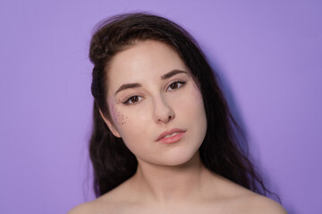 pretty brunette girl woman on Very Peri background. trendy color 2022. light purple.