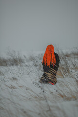Beautiful young woman standing in the field