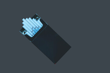 open pack of thin long cigarettes on a dark  background