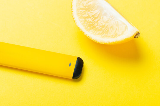 Electronic cigarettes with different fruit flavors with ingredients on colored backgrounds