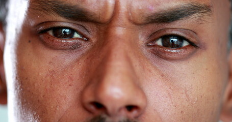 Suspicious Man has a serious look on his face. Closeup of man frowning and with an angry face