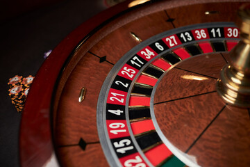 casino roulette wheel, casino gambling concept. Roulette table in a casino, with many games and slots, roulette wheel in the foreground. Casino roulette close-up. gambling for money.