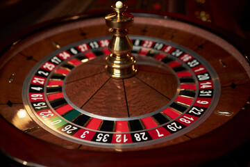 casino roulette wheel, casino gambling concept. Roulette table in a casino, with many games and slots, roulette wheel in the foreground. Casino roulette close-up. gambling for money.