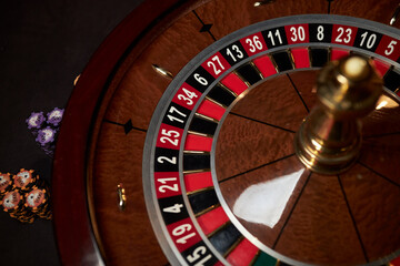 casino roulette wheel, casino gambling concept. Roulette table in a casino, with many games and...