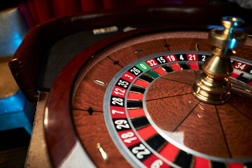 casino roulette wheel, casino gambling concept. Roulette table in a casino, with many games and...