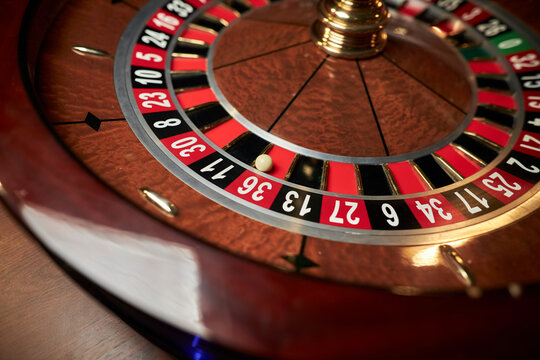 casino roulette wheel, casino gambling concept. Roulette table in a casino, with many games and slots, roulette wheel in the foreground. Casino roulette close-up. gambling for money.