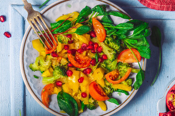 Fresh colorful spring vegetable salad with cherry tomatoes and sweet peppers. Healthy vegan lunch