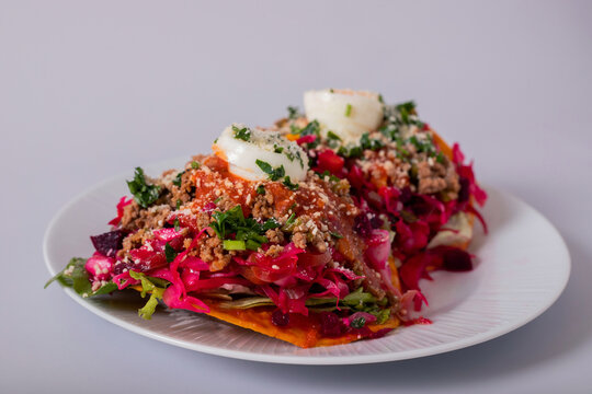Enchilada Guatemalteca set on a white plate and white background