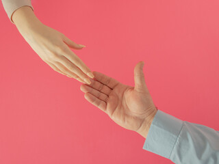 Love with man and women hand against pink background. creative valentines adorable decoration idea