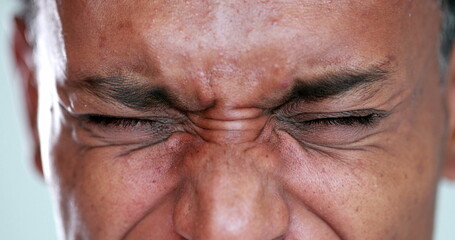 Person close-up eyes closed feeling upset feeling emocional, squinting eyesight