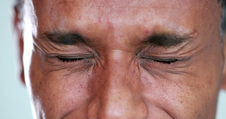 Person close-up eyes closed feeling upset feeling emocional, squinting eyesight