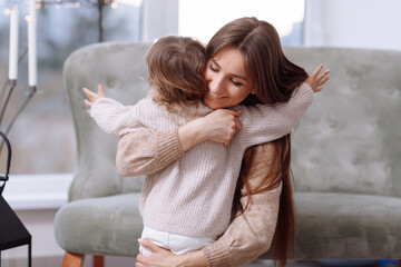 mother s day. Portrait of little preschool girl kid excited young mother have fun playing together at studio, happy mom and daughter hug cuddle show love, enjoy family relaxing weekend on sofa.