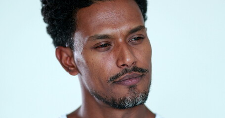 Obraz premium Pensive African man close-up face portrait. Thoughtful black person thinking about solution