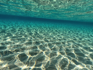 Underwater split photo of paradise exotic island beach with crystal clear turquoise sea in exotic destination island